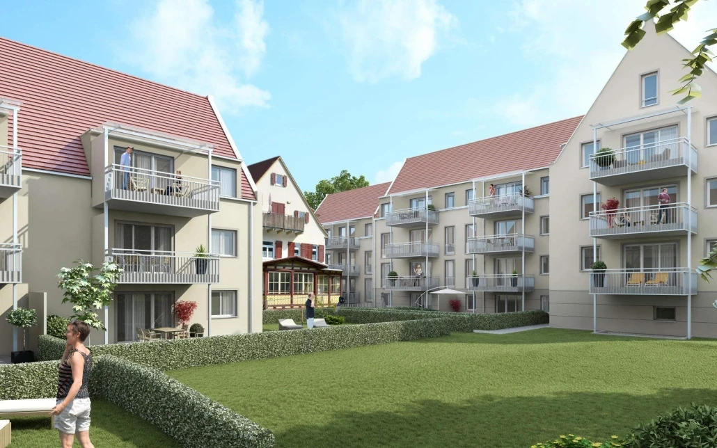 Moderne Mehrfamilienhäuser mit Balkonen umgeben einen gepflegten Innenhof mit grünem Rasen, Hecken und einigen Menschen, die an einem sonnigen Tag den Außenbereich genießen – ein Beispiel für den durchdachten Entwurf und die sorgfältige Projektentwicklung von SCHATZ Architektur.