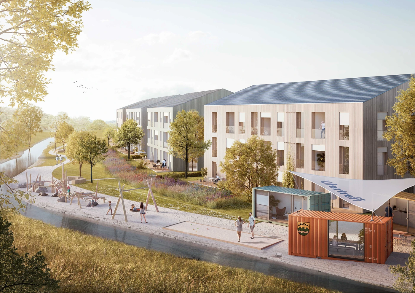 Eine moderne Wohnanlage mit dreistöckigen Gebäuden, Grünflächen, Bäumen, Schaukeln auf dem Spielplatz, Spaziergängern und einem orangefarbenen Container, der als kleines Café oder Kiosk genutzt wird – sorgfältig gestaltet im Rahmen der Projektentwicklung von SCHATZ Architektur. Entlang des Weges verläuft ein Kanal.