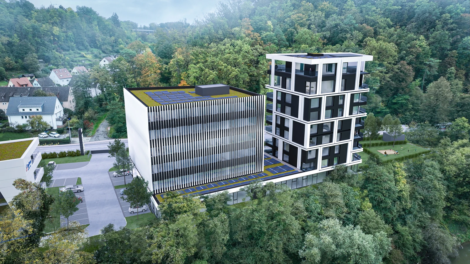 Architektur Luftaufnahme von zwei modernen Gebäuden mit Solaranlagen auf dem Dach, umgeben von Bäumen und Wohnhäusern; eines der Gebäude ist höher und verfügt über Balkone, beide haben begrünte Dächer.
